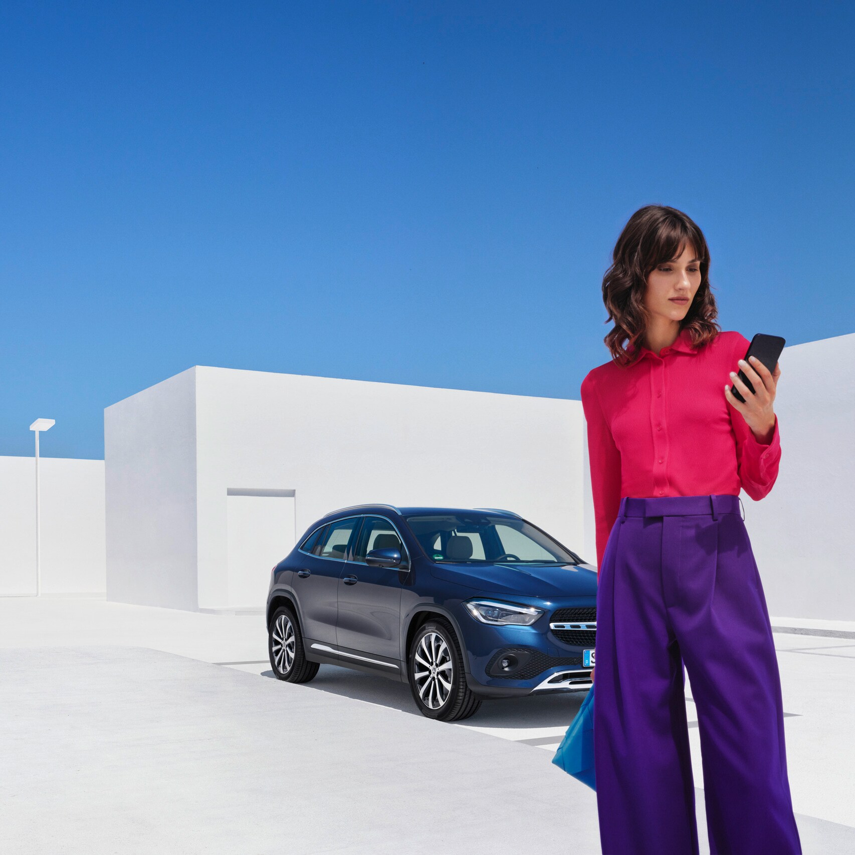 Una persona usando su teléfono móvil para comunicarse con Mercedes-Benz.